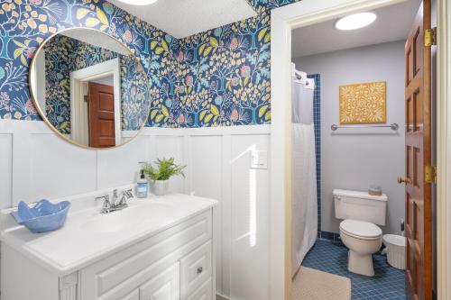 a bathroom with a sink and a mirror and a toilet at Days To Remember villa by Peace Vacations in Georgetown