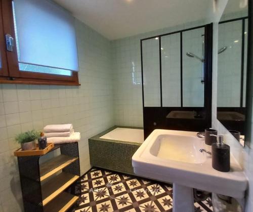 a bathroom with a sink and a bath tub at L'Horizon Bleu, Splendide vue sur le Lac Annecy, à 3mn du Lac in Veyrier-du-Lac