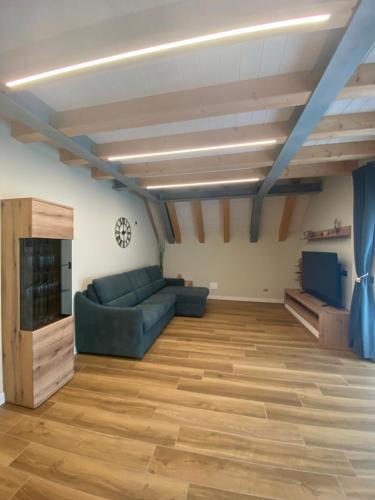 a large living room with a couch and a tv at Klamora House in Tarvisio
