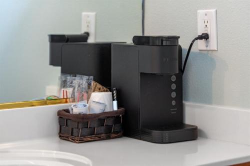 a coffee maker sitting on a counter with a basket at NEW King Bed,Suite,Downtown BR Southern Charm Boxcar in Blue Ridge