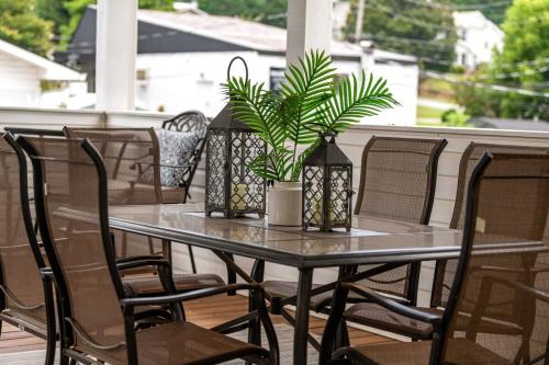 a table and chairs on a porch with a plant at NEW King Bed,Suite,Downtown BR Southern Charm Boxcar in Blue Ridge
