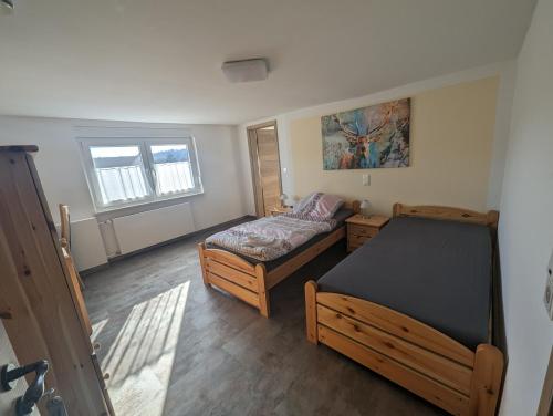 a bedroom with two beds and a window at Pension Neue Linde in Alsfeld