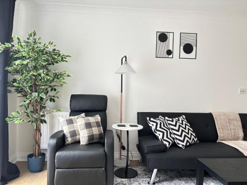 a living room with a couch and a chair at 2BR 2BA Flat - King Beds - Free Parking - Near LGW Airport in Crawley