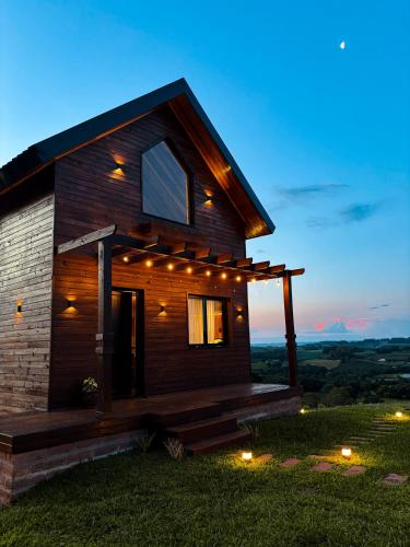 a house with lights on the side of it at Rifugio d Ferrari in Pinto Bandeira