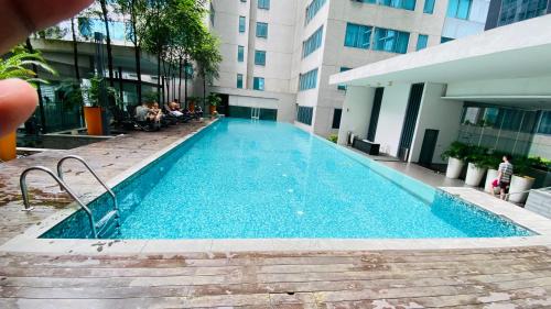 a swimming pool in the middle of a building at Summer Suites by Western Holiday in Kuala Lumpur