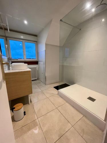 une grande salle de bain avec douche et lavabo dans l'établissement Le bon’heurt, à Le Portel