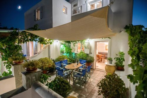 a patio with a table and chairs and plants at Kontaratos Studios & Apartments in Parikia