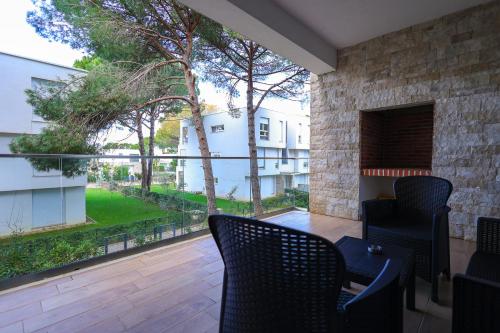a balcony with chairs and a view of a building at SanPietro Vacation Apartments in Durrës