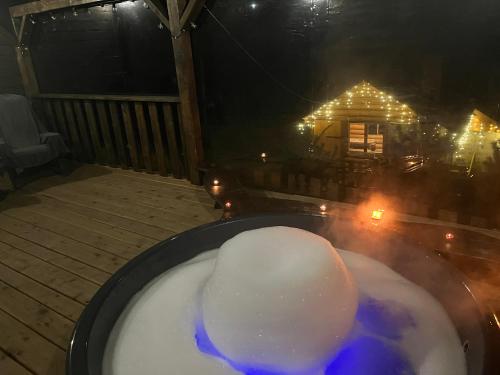 a tub of snow on a deck with a house at Hirska Vatra in Slavske