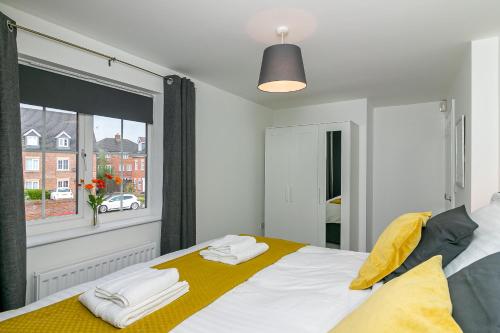a bedroom with a bed with towels on it at Three Bedroom Apartment By Vesta Serviced Accommodation & Short Lets Hatfield With Free Parking in Hatfield