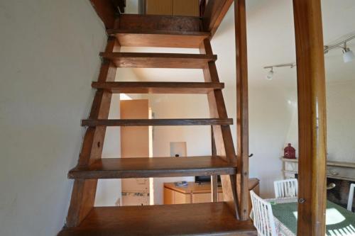 a wooden spiral staircase in a room at CASA SANT`ANNA DI STAZZEMA in Culla