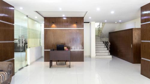 an office lobby with a desk and a staircase at Itsy By Treebo - Tals Hytek in Hyderabad