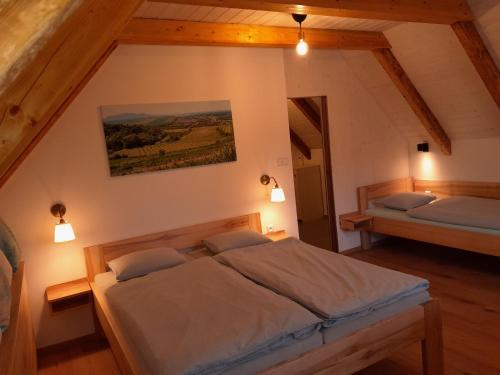 a bedroom with two beds in a attic at Ubytování Na sklepě u Procházků in Pouzdřany
