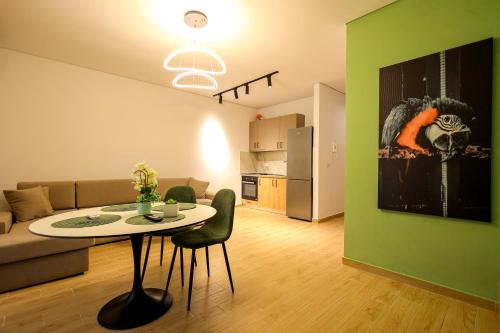 a living room with a table and a couch at SanPietro Vacation Apartments in Durrës
