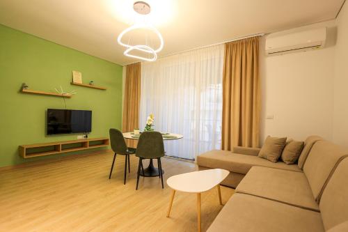a living room with a couch and a table at SanPietro Vacation Apartments in Durrës