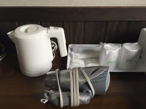a blender and other appliances sitting on a shelf at Ryokan Yufusan in Yufuin