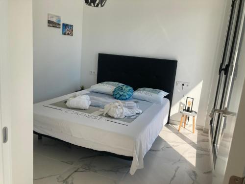 a bedroom with a bed with towels on it at micasa in Denia