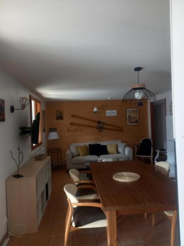a living room with a table and a couch at La soulane in Ax-les-Thermes