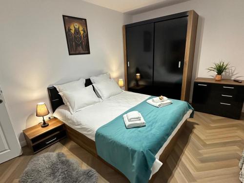 a bedroom with a bed with a blue blanket at Casa Dana in Iaşi