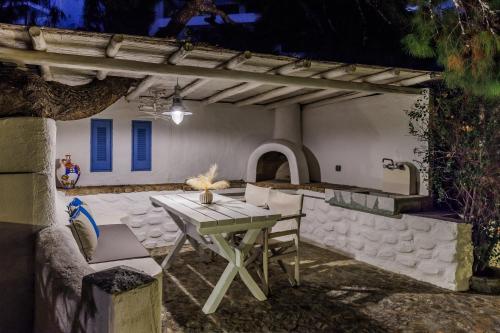 a patio with a table and chairs in front of a building at Evlalia Studios & Villas in Skopelos Town