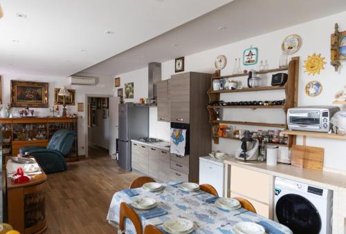 a kitchen and living room with a table in it at Il giardino di Ve' in Lecce