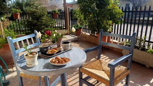 a table with a plate of food on a patio at Cozy γωνιά στο χωριό in Lianokládhion