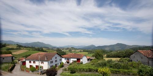 a view of a village with mountains in the background at Hotel Restaurant Pecoitz in Saint-Jean-Pied-de-Port