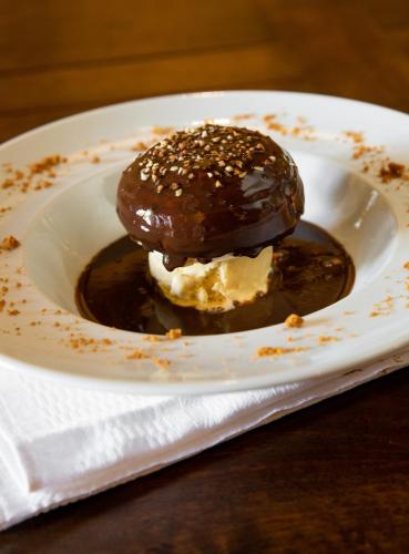 a chocolate covered ice cream on a white plate at Hotel Restaurant Pecoitz in Saint-Jean-Pied-de-Port