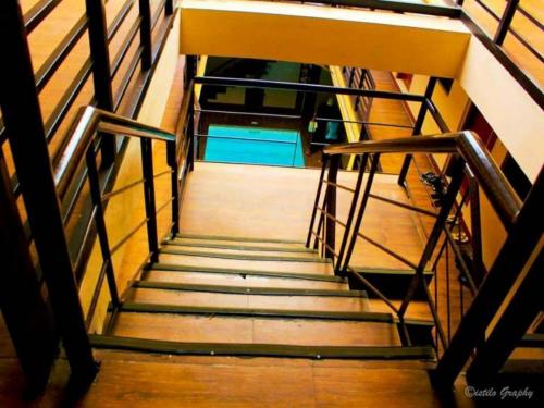a flight of stairs with a stair case in a building at Hidden Pearl Hotel (Janus Luxury Suites) in Angeles