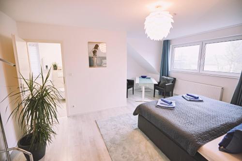 a bedroom with a bed and a table in a room at Bildstein's "Kathmandu" in Langenfeld