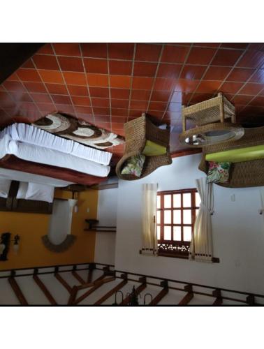a room with several bunk beds on the ceiling at Hotel Bosque de la Villa in Villa de Leyva