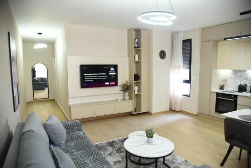 a living room with a couch and a table at Seaside Grand Stay Apartment in Durrës