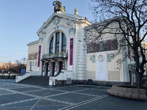 a white building with a statue on top of it at Moderní studio v centru Pardubic - Netflix, Wi-Fi zdarma in Pardubice