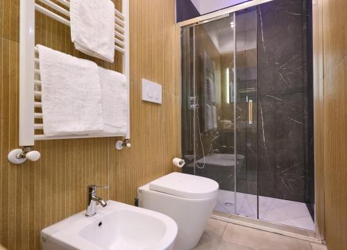 a bathroom with a shower and a toilet and a sink at The Sweet Spot in Torre del Greco