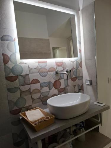 a bathroom with a sink and a mirror at The Sweet Spot in Torre del Greco