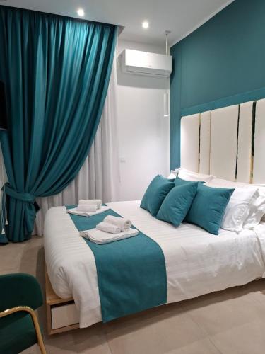 a bedroom with a large bed with blue walls at The Sweet Spot in Torre del Greco