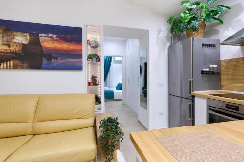 a living room with a yellow couch in a kitchen at The Sweet Spot in Torre del Greco