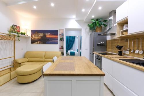 a kitchen with a table and a couch in a room at The Sweet Spot in Torre del Greco