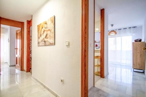 a hallway with a painting on a wall at Apartment 2 minutes from the beach in Albir