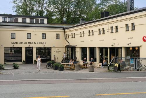 a building with people sitting outside of it at Fantastic apartment on prime location in Oslo