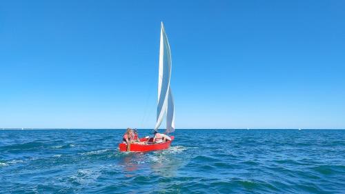 two people on a sail boat in the ocean at La Villa des Dunes bord de mer in Loctudy