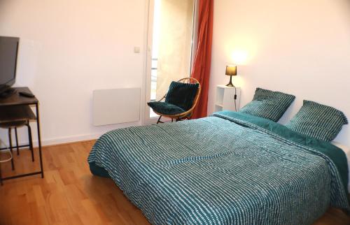 une chambre avec un lit, un bureau et une fenêtre dans l'établissement Le Madeleine - Parking gratuit- Balcon - Fibre, à Orléans