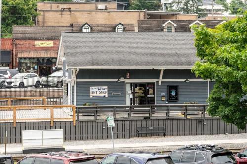 a blue building with cars parked in front of it at Penthouse Suite Right in the Heart of Downtown - Trackside in Blue Ridge