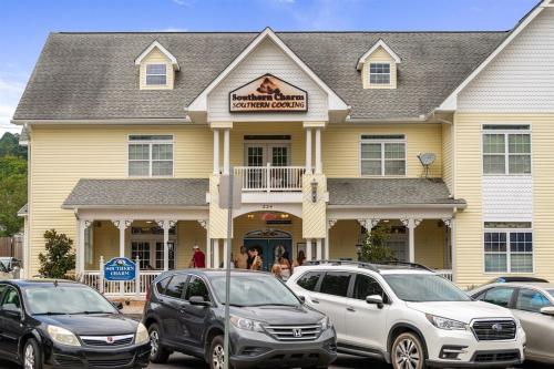 a large yellow house with cars parked in front of it at Penthouse Suite Right in the Heart of Downtown - Trackside in Blue Ridge