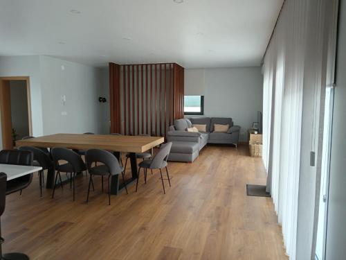 a living room with a table and chairs and a couch at Casa de Lazer da Chã in Alqueidão da Serra