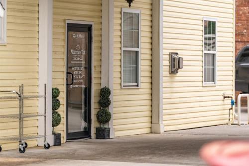 a building with a door with a sign on it at Penthouse Suite Right in the Heart of Downtown - Trackside in Blue Ridge