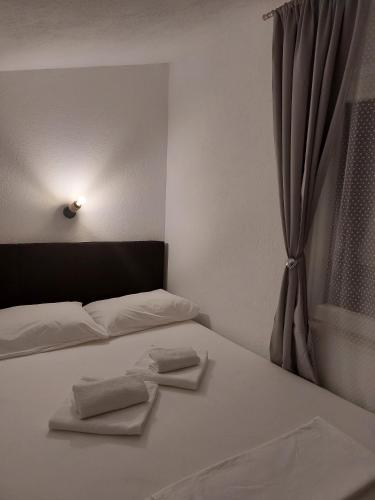a bedroom with a bed with two towels on it at App Paula1 in Trogir