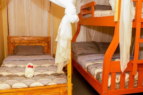 a bedroom with two bunk beds and a stuffed animal at Amanya 2-Bedroom Self Catering Tent in Amboseli