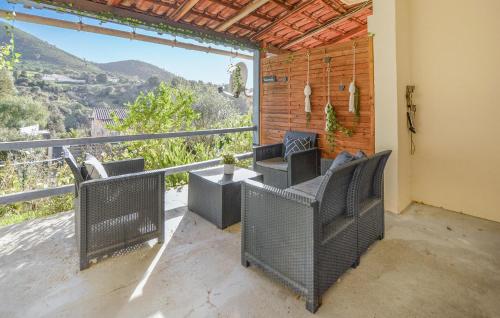 a balcony with chairs and a view of a mountain at Awesome Apartment In Sarrola Carcopino in Sarrola-Carcopino