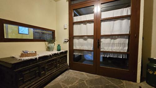 a room with a wooden door and a window at Cal Brugués - Casa de montanya in Ribes de Freser